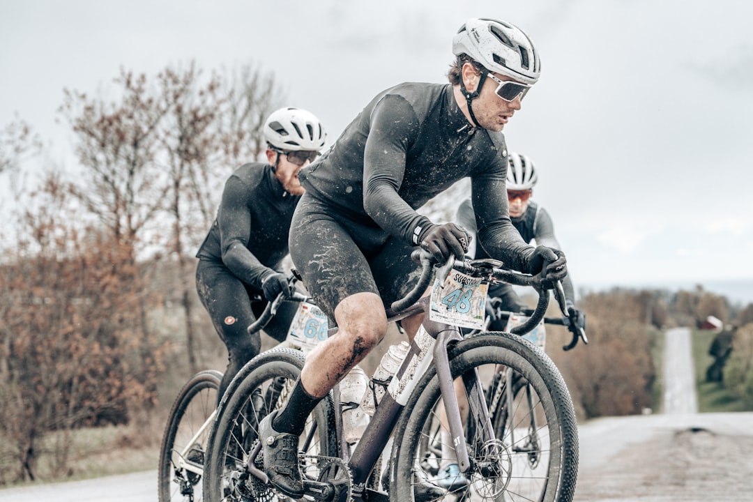 muddy riders in a gravel race after a big climb